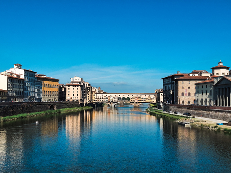 Firenze Italy 26 April 2026 View of Ponte Vecchio spanning the Arno River surrounded by historic buildings under a clear blue sky in Firenze Italy.