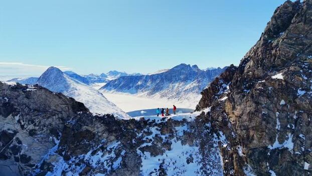 Aerial view of people on a mountain ridge in Tasiilaq Greenland. Aerial view of people on a mountain ridge in Tasiilaq Greenland.