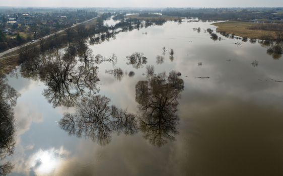 Aerial view of the flooded river landscape with submerged trees and cloud reflections on the water surface in Kedainiai Kaunas County Lithuania. Aerial view of the flooded river landscape with submerged trees and cloud reflections on the water surface in Kedainiai Kaunas County Lithuania.