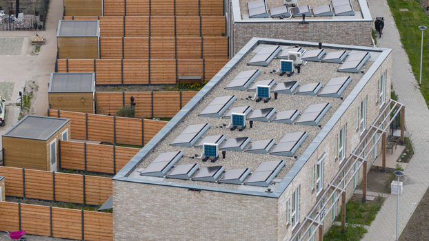 Aerial view of modern residential buildings with solar panels on flat roofs and wooden garden fences Almere Flevoland Netherlands. Aerial view of modern residential buildings with solar panels on flat roofs and wooden garden fences Almere Flevoland Netherlands.