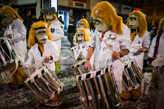 Basel Switzerland 10 March 2025 View of Fasnacht street performers in gorilla masks beat drums their striking white outfits contrasting the shadowy street. Basel Switzerland 10 March 2025 View of Fasnacht street performers in gorilla masks beat drums their striking white outfits contrasting the shadowy street.
