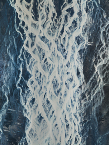 Aerial view of glacial rivers carve through the stark icy landscape creating a mesmerizing network of white veins against the dark terrain Iceland. Aerial view of glacial rivers carve through the stark icy landscape creating a mesmerizing network of white veins against the dark terrain Iceland.