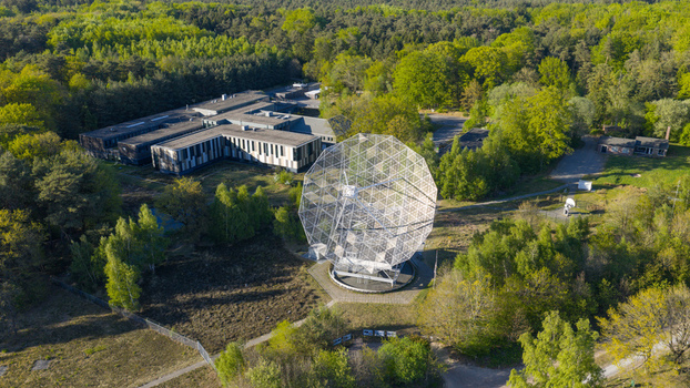 Aerial view of the Radiotelescoop surrounded by dense green forest and research facilities in Dwingeloo Drenthe Netherlands.