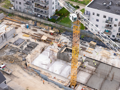 Aerial view of a construction site with a yellow tower crane workers concrete foundations and rebar in Gdansk Poland. Aerial view of a construction site with a yellow tower crane workers concrete foundations and rebar in Gdansk Poland.