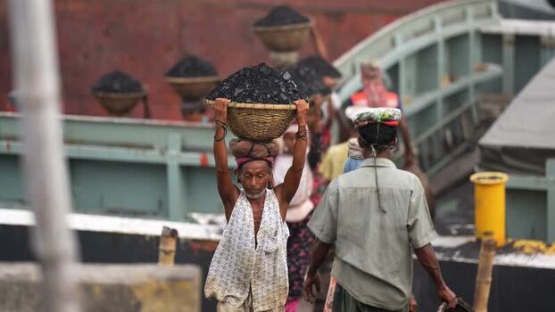 View of workers carrying coal baskets in Aminbazar Bangladesh.