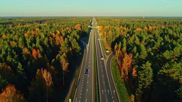 Aerial view of highway through forest in Latvia.