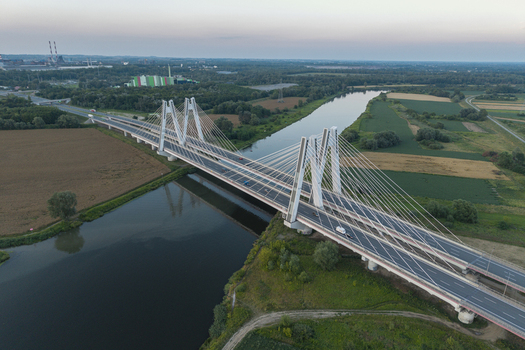 Aerial view of Most na S7 cable stayed bridge spanning the Vistula River surrounded by green fields and rural landscape in Krakow Malopolskie Poland. Aerial view of Most na S7 cable stayed bridge spanning the Vistula River surrounded by green fields and rural landscape in Krakow Malopolskie Poland.