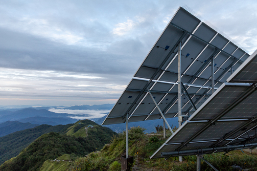 Pokhara Gandaki Province Nepal 27 August 2026 View of solar panels on a mountain ridge overlooking the green peaks and valleys of the Mardi Himal Trek under a cloudy sky.