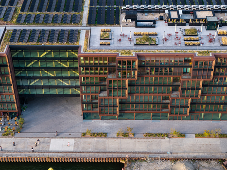 Aerial view of Spreespeicher Promenade featuring modern architecture with a green roof and solar panels along the Spree river in Berlin Berlin Germany. Aerial view of Spreespeicher Promenade featuring modern architecture with a green roof and solar panels along the Spree river in Berlin Berlin Germany.