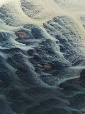 Aerial view of glacial rivers intertwine like delicate brushstrokes across the stark landscape a symphony of icy blues and earthy browns Iceland Iceland. Aerial view of glacial rivers intertwine like delicate brushstrokes across the stark landscape a symphony of icy blues and earthy browns Iceland Iceland.