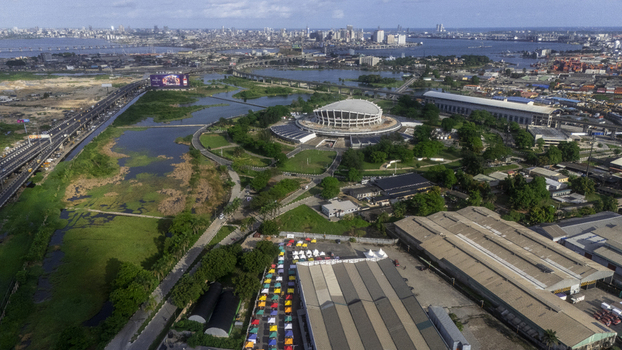 Aerial view of the National Theatre Nigeria with its unique architecture surrounded by lush greenery and the urban skyline of Lagos Lagos Nigeria.