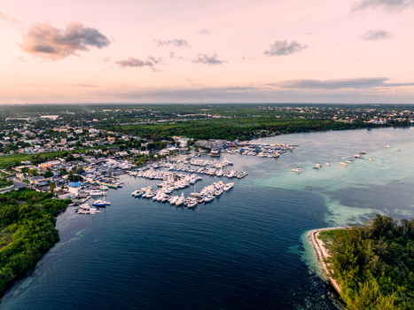 Aerial view of Club Nautico de Santo Domingo marina with yachts and boats along the coast with lush vegetation and urban surroundings at sunset Andres Santo Domingo Dominican Republic. Aerial view of Club Nautico de Santo Domingo marina with yachts and boats along the coast with lush vegetation and urban surroundings at sunset Andres Santo Domingo Dominican Republic.