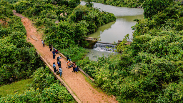 Aerial view of Lamingo Dam with people on a bridge near lush greenery in Jos Jarawa Plateau Nigeria. Aerial view of Lamingo Dam with people on a bridge near lush greenery in Jos Jarawa Plateau Nigeria.