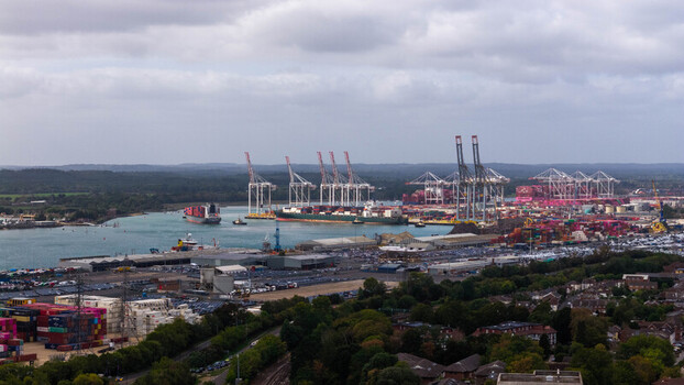 Aerial view of the busy container terminal at the Port of Southampton with cargo ships towering cranes and stacks of shipping containers Southampton England United Kingdom. Aerial view of the busy container terminal at the Port of Southampton with cargo ships towering cranes and stacks of shipping containers Southampton England United Kingdom.
