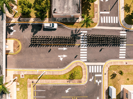 Aerial view of the Base de Infanteria de Marina Valm. Manuel Ramon Montes Arache with marines marching in formation on the asphalt road in Boca Chica Santo Domingo Dominican Republic. Aerial view of the Base de Infanteria de Marina Valm. Manuel Ramon Montes Arache with marines marching in formation on the asphalt road in Boca Chica Santo Domingo Dominican Republic.