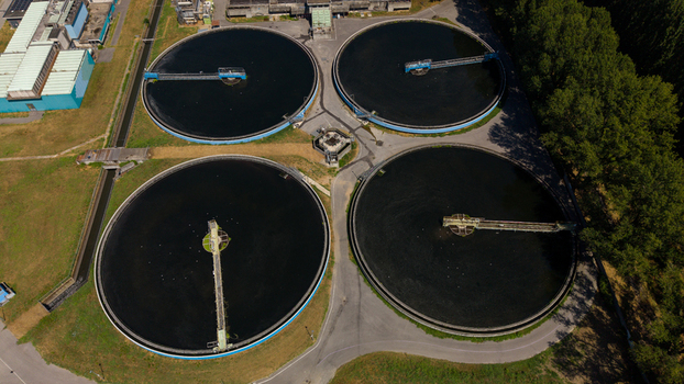 Aerial view of a wastewater treatment plant with four large circular sedimentation tanks located in Milan Lombardy Italy. Aerial view of a wastewater treatment plant with four large circular sedimentation tanks located in Milan Lombardy Italy.