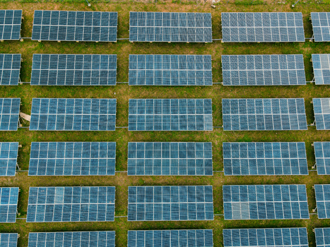 Aerial view of solar panels arranged in neat rows on a grassy field in Ogun State Nigeria.