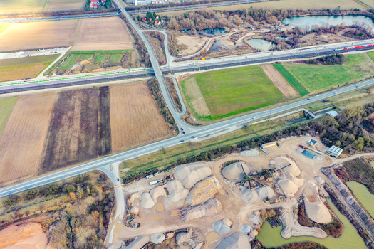 Aerial view of the rural landscape featuring agricultural fields road intersections and a sand quarry with industrial piles Buttenheim Bavaria Germany. Aerial view of the rural landscape featuring agricultural fields road intersections and a sand quarry with industrial piles Buttenheim Bavaria Germany.