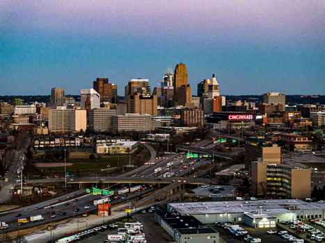 Aerial view of the city skyline and the Cincinnati Reds stadium under a twilight sky showcasing the vibrant urban landscape Cincinnati Ohio United States. Aerial view of the city skyline and the Cincinnati Reds stadium under a twilight sky showcasing the vibrant urban landscape Cincinnati Ohio United States.