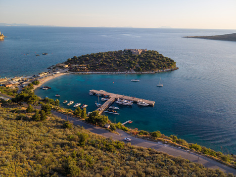 Aerial view of Porto Palermo Castle on a small peninsula with a pier full of boats and yachts in the turquoise bay Porto Palermo Qarku i Vlores Albania. Aerial view of Porto Palermo Castle on a small peninsula with a pier full of boats and yachts in the turquoise bay Porto Palermo Qarku i Vlores Albania.