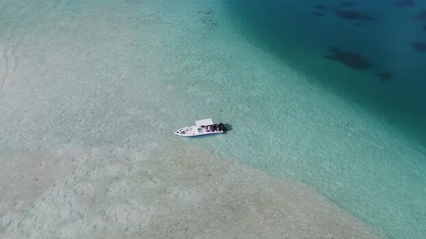 Aerial view of a boat in turquoise waters Maldives.
