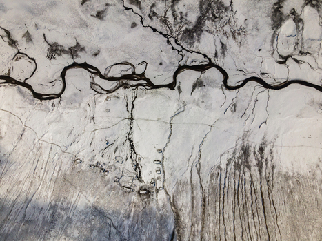 Aerial view of the winding river and snow covered terrain at Babusar Pass with small mountain shelters in Babusar KPK Pakistan. Aerial view of the winding river and snow covered terrain at Babusar Pass with small mountain shelters in Babusar KPK Pakistan.