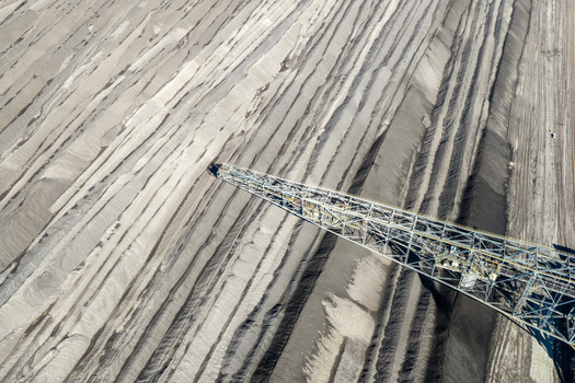 Aerial view of Tagebau Welzow Sud brown coal open pit mine with a bucket wheel excavator over the terraced dark earth layers of the mining site Spremberg Brandenburg Germany. Aerial view of Tagebau Welzow Sud brown coal open pit mine with a bucket wheel excavator over the terraced dark earth layers of the mining site Spremberg Brandenburg Germany.