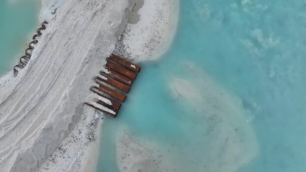Aerial view of land reclamation and rusty pipes in Gulhi Maldives.