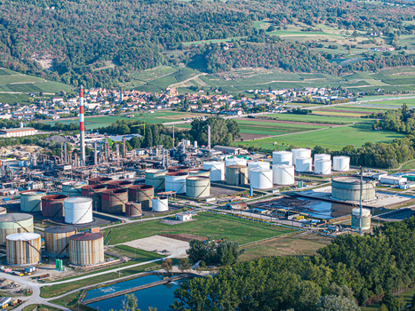 Aerial view of the Cressier Refinery with its industrial storage tanks processing towers and surrounding green fields and vineyards in Cornaux Neuchatel Switzerland. Aerial view of the Cressier Refinery with its industrial storage tanks processing towers and surrounding green fields and vineyards in Cornaux Neuchatel Switzerland.