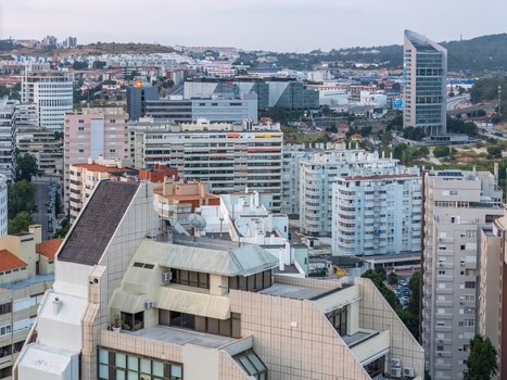 Aerial view of the dense urban landscape featuring modern residential buildings and high rise architecture under a clear sky in Lisbon Lisbon Portugal.