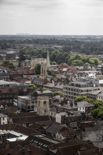 Aerial view of York Minster and the historic city center with red tiled rooftops stone buildings and lush green trees in York England United Kingdom.