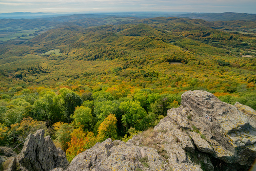 Aerial view of Sitno in Stiavnicke Vrchy with vibrant autumn foliage covering the rolling hills and rocky outcrops Ilija Banska Bystrica Regio Slovakia.