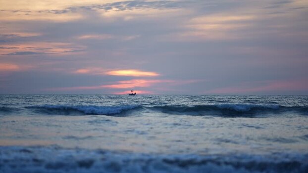 View of a small boat at sunset on the sea in Cox s Bazar Bangladesh View of a small boat at sunset on the sea in Cox s Bazar Bangladesh