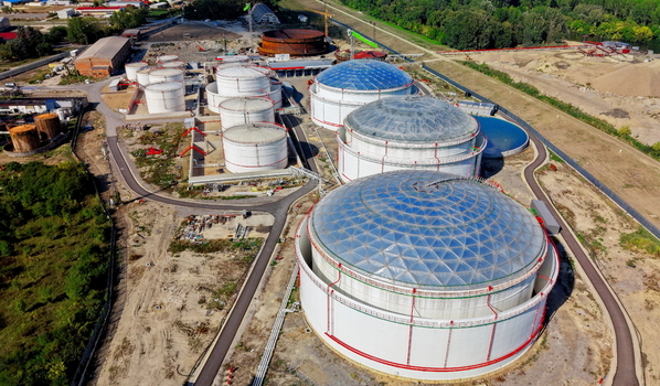 Aerial view of large industrial oil storage tanks with domed roofs situated in a facility with paved paths and surrounding greenery in Kovin Vojvodina Serbia. Aerial view of large industrial oil storage tanks with domed roofs situated in a facility with paved paths and surrounding greenery in Kovin Vojvodina Serbia.