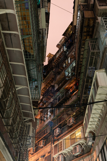 View of dense residential buildings with numerous air conditioning units and metal balconies in a narrow urban alleyway in Guangfu Village Taipei City Taiwan. View of dense residential buildings with numerous air conditioning units and metal balconies in a narrow urban alleyway in Guangfu Village Taipei City Taiwan.
