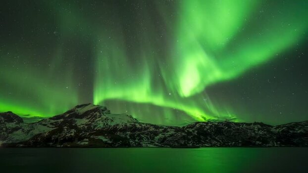 View of aurora borealis over the mountains in Lofoten Norway. View of aurora borealis over the mountains in Lofoten Norway.