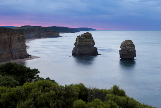 View of the limestone stacks of Twelve Apostles Marine National Park with rugged cliffs and a twilight sky over the ocean Australia. View of the limestone stacks of Twelve Apostles Marine National Park with rugged cliffs and a twilight sky over the ocean Australia.
