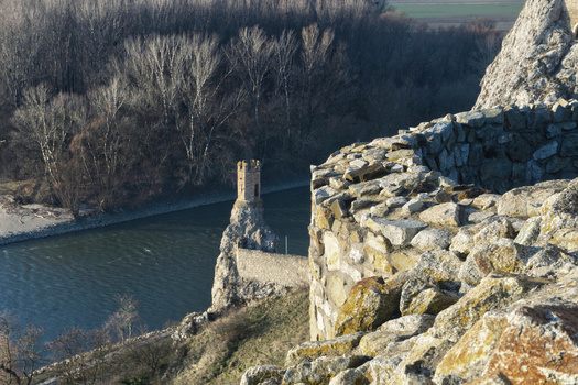 View of the historic Devin Castle stone walls and the Maiden Tower overlooking the river and winter forest in Bratislava IV Bratislava Region Slovakia. View of the historic Devin Castle stone walls and the Maiden Tower overlooking the river and winter forest in Bratislava IV Bratislava Region Slovakia.