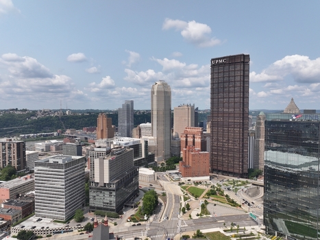 Pittsburgh United States 26 July 2026 Aerial view of the downtown skyline featuring the UPMC building modern skyscrapers and urban infrastructure under a partly cloudy sky.
