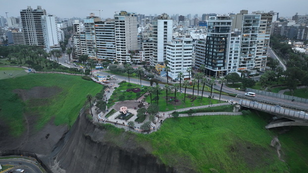 Aerial view of Parque del Amor with its iconic sculpture lush green gardens and surrounding modern high rise buildings along the coastal cliffs in Miraflores Provincia de Lima Peru. Aerial view of Parque del Amor with its iconic sculpture lush green gardens and surrounding modern high rise buildings along the coastal cliffs in Miraflores Provincia de Lima Peru.
