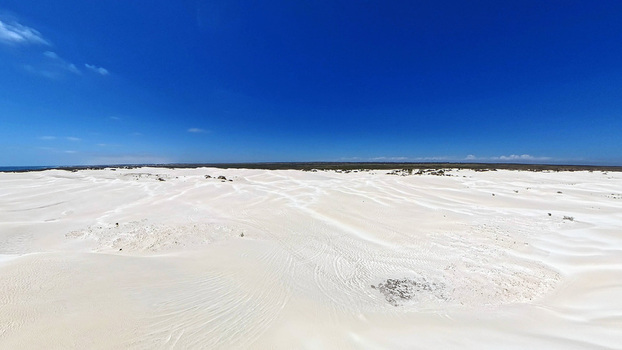 Aerial view of Lancelin Sand Dunes with vast white sand formations under a clear blue sky in Lancelin Western Australia Australia. Aerial view of Lancelin Sand Dunes with vast white sand formations under a clear blue sky in Lancelin Western Australia Australia.