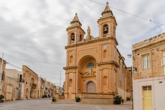 View of the Parish Church of Our Lady of Pompei a stunning golden building standing proudly in the heart of the town Marsaxlokk Malta. View of the Parish Church of Our Lady of Pompei a stunning golden building standing proudly in the heart of the town Marsaxlokk Malta.