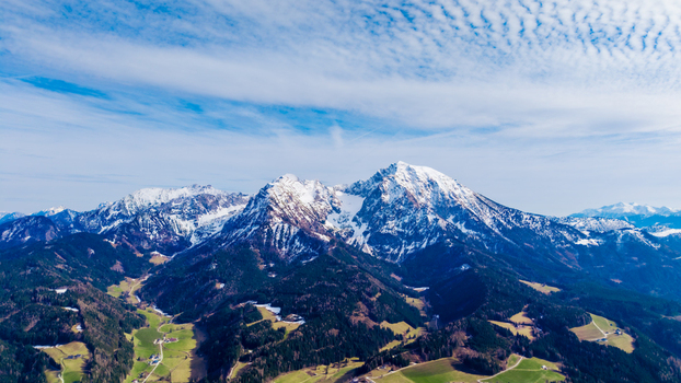 Aerial view of snow dusted peaks pierce the sky contrasting with the verdant valley below a tapestry of nature s grandeur Windischgarsten Upper Austria Austria. Aerial view of snow dusted peaks pierce the sky contrasting with the verdant valley below a tapestry of nature s grandeur Windischgarsten Upper Austria Austria.
