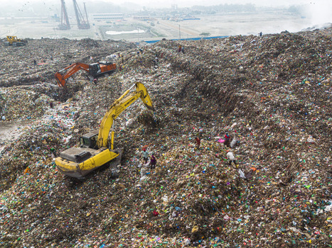 Aminbazar Bangladesh 26 January 2025 Aerial view of the massive Aminbazar landfill with excavators and waste pickers working on vast piles of garbage under a hazy sky. Aminbazar Bangladesh 26 January 2025 Aerial view of the massive Aminbazar landfill with excavators and waste pickers working on vast piles of garbage under a hazy sky.