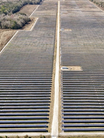 Aerial view of vast solar panel array stretching across the landscape a stark contrast to the bordering trees Elkton Florida United States. Aerial view of vast solar panel array stretching across the landscape a stark contrast to the bordering trees Elkton Florida United States.