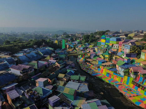 Aerial view of the vibrant Kampung Warna Warni Jodipan with its brightly painted houses lining the river in Kecamatan Blimbing Jawa Timur Indonesia. Aerial view of the vibrant Kampung Warna Warni Jodipan with its brightly painted houses lining the river in Kecamatan Blimbing Jawa Timur Indonesia.