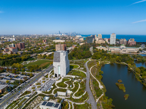 Aerial view of The Obama Presidential Center surrounded by parkland and winding paths with the Chicago skyline and Lake Michigan in the distance Chicago Illinois United States. Aerial view of The Obama Presidential Center surrounded by parkland and winding paths with the Chicago skyline and Lake Michigan in the distance Chicago Illinois United States.