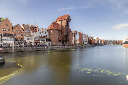 Gdansk Pomeranian Voivodeship Poland 05 September 2026 View of the historic Crane on the Motlawa River waterfront surrounded by colorful brick buildings and traditional architecture. Gdansk Pomeranian Voivodeship Poland 05 September 2026 View of the historic Crane on the Motlawa River waterfront surrounded by colorful brick buildings and traditional architecture.