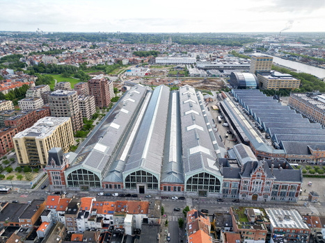 Aerial view of the Gare Maritime building at the Tour and Taxis site featuring historic industrial architecture with glass roofs and modern urban development Brussels Brussels Belgium.