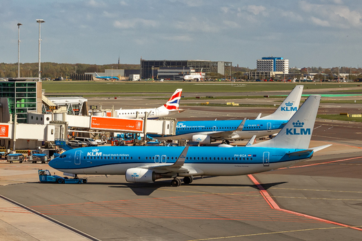 Schiphol Netherlands 16 April 2026 View of KLM Royal Dutch Airlines airplanes parked at terminal gates with ground handling equipment and airport buildings under a cloudy sky. Schiphol Netherlands 16 April 2026 View of KLM Royal Dutch Airlines airplanes parked at terminal gates with ground handling equipment and airport buildings under a cloudy sky.